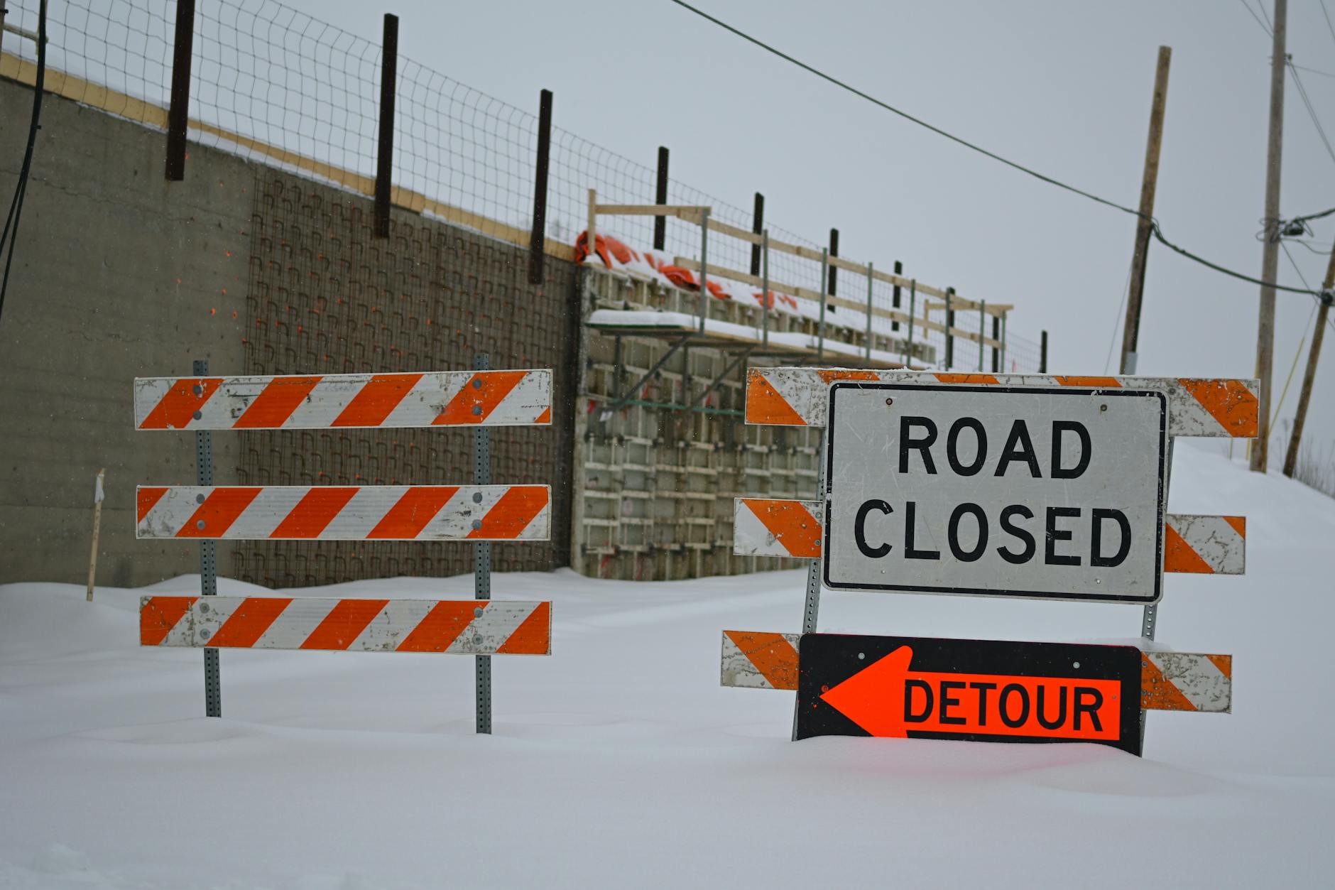 winter road construction with detour signage